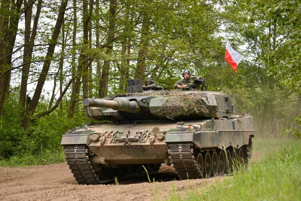 A Polish army Leopard tank returns to the tactical assembly area to prepare for a Defender Europe multinational situational exercise at Drawsko Pomorskie, Poland, May 25, 2022. Defender Europe 22 is a series of U.S. Army Europe and Africa multinational training exercises taking place in Eastern Europe. The exercise demonstrates U.S. Army Europe and Africa’s ability to conduct large-scale ground combat operations across multiple theaters in support of NATO. (U.S. Army photo by Capt. Tobias Cukale)