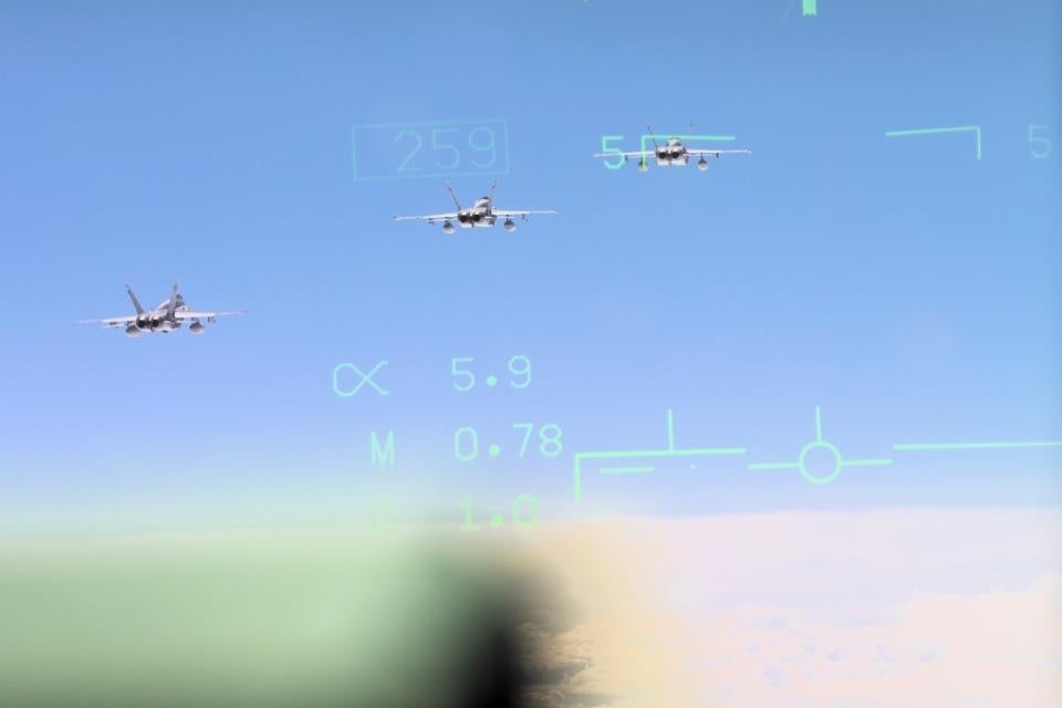 Three Finnish F/A-18 viewed through the heads-up display of another Finnish fighter pilot during deployment flight. (Finnish Air Force)