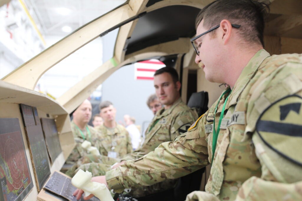 During the Future Long Range Assault Aircraft (FLRAA) Soldier Touch Point (STP) aircraft crew members reviewed notional cockpit layout and design. (photo credit: CPT William Derrick, 1ACB)