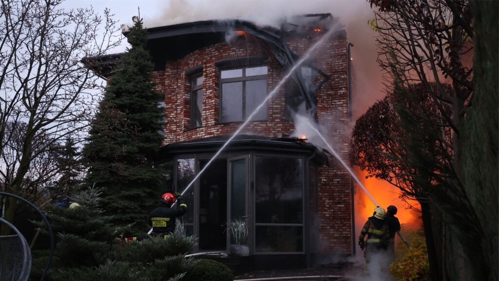 Ukrainian firefighters work to extinguish a fire at a house caused by a Russian missile attack on the city of Dnipro on 21 November (State Emergency Service of Ukraine)