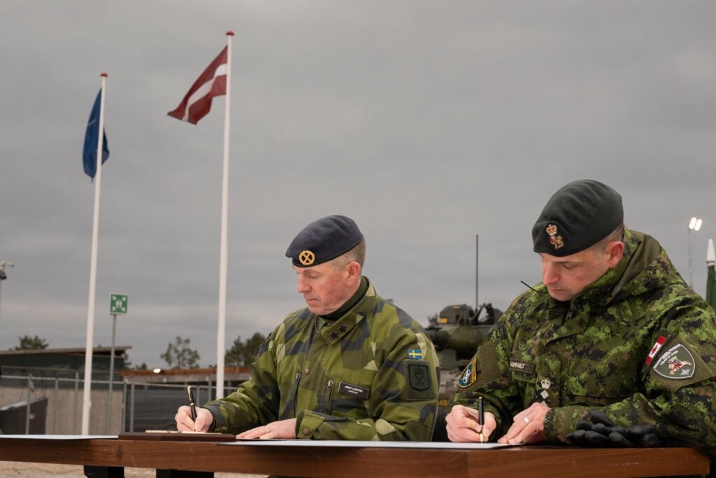 Swedish Army chief Major General Jonny Lindfors signs the transfer of authority papers (Swedish Combat Camera)