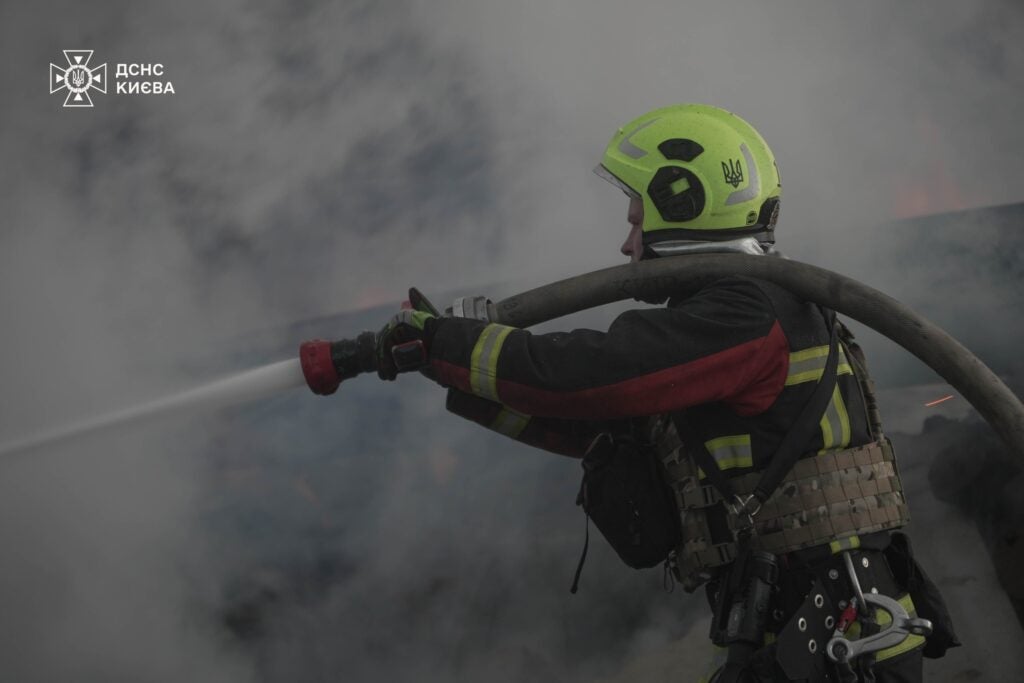 An Ukrainian firefighter in Kyiv works to extinguish a fire started by a Russian missile attack that killed 1 person and injured four as of writing (State Emergency Service of Ukraine)